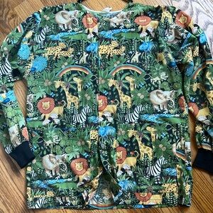 Jungle print scrub jacket. Snap closure. Knit cuffs. 2 pockets Small